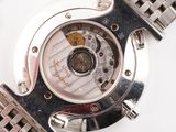 a close up of a watch on a white surface