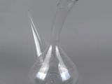 a close up of a clear glass vase on a gray surface