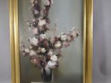une photo d'un tableau de fleurs dans un cadre doré
