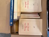 boxes of books are stacked on top of each other on the floor