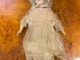 a doll that is laying down on a wooden floor