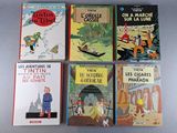 several children ' s books are lined up on a table