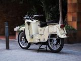 a moped that is parked on the side of the street