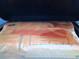 a bag of food inside of a suitcase on the floor