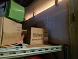 boxes are stacked on top of a shelf in a room