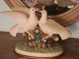 two birds that are sitting on top of a tree stump