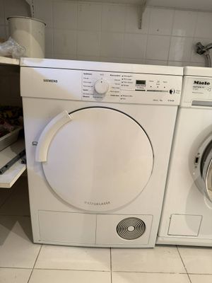 a white washer and dryer in a small room
