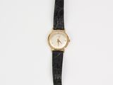 a black and gold watch with a white face on a black strap