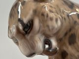 a figurine of a dog that is sitting on a table