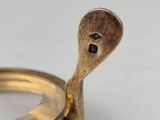a close up of a magnifying glass with a wooden handle