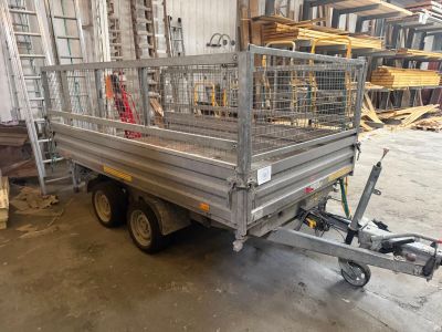 a trailer with a cage on the back of it in a warehouse
