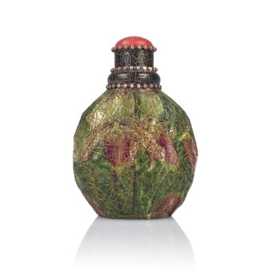 a small glass bottle with a red cap on it