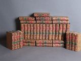 many books stacked on top of each other on a table