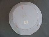 a white plate with a sticker on it sitting on a table