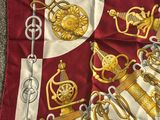 an image of a red and white scarf with gold decorations on it