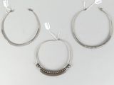three silver hoop earrings with beaded details on a white background
