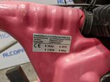 a close up of a pink motorcycle with a sticker on it