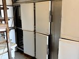 several refrigerators are lined up in a kitchen with a ladder in front of them