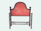 a bed with a red headboard and a metal frame