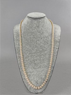 a necklace with pearls and gold beads on a mannequin