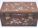 a small wooden box with a floral design on it