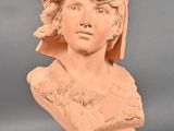 a close up of a bust of a woman wearing a hat