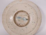 a white plate with a blue fish on it