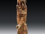 an ancient statue of a woman holding a baby