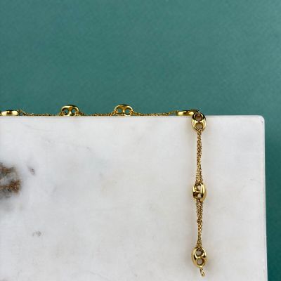 marble slab with a gold chain on top of it on a blue background