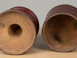 two wooden vases sitting on a table next to each other
