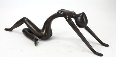 statue of a woman laying on her back on a white surface