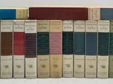 a lot of books that are lined up on a shelf