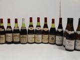 several bottles of wine are lined up in a row on a table