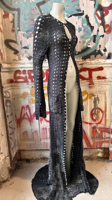 an image of a mannequin in front of a graffiti covered wall