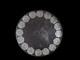 a black and white plate with a circular design on it