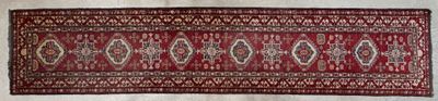 an old rug with a red and white design on it