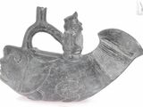 a black and white photo of a figurine of a fish
