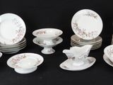 many plates and cups and saucers on a black table