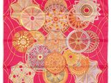 a pink scarf with a bunch of different designs on it