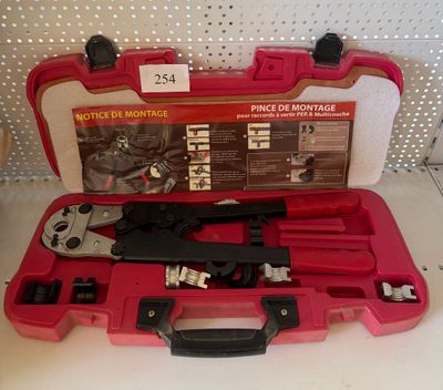 a red tool case with tools in it on a white surface