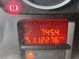 a close up of a car ' s dashboard with a digital clock