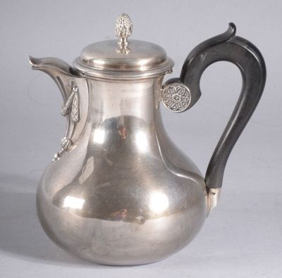 une théière ancienne en argent ornée d'un oiseau sur l'anse