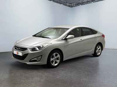 the silver car is parked in a large room with a white wall
