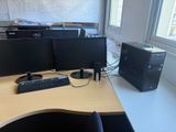 a desk with two computer monitors and a keyboard on it