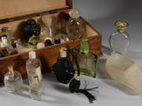 a wooden box filled with various bottles and a feather