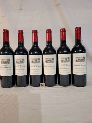 six bottles of wine are lined up on a table