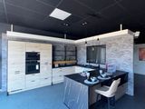 an image of a kitchen with a dining table and chairs