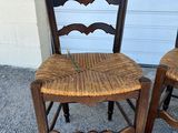 pair of antique ladder back chairs with wicker seats