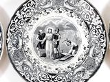 several black and white plates with a picture of a man and a woman on them