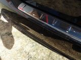 a close up of a car ' s bumper with the door handle missing